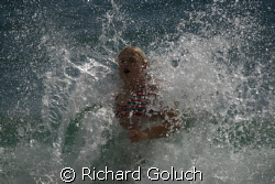 Splashing in water of the coast of Kauai after a dive. by Richard Goluch 
